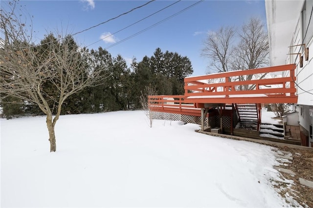 yard layered in snow featuring a deck