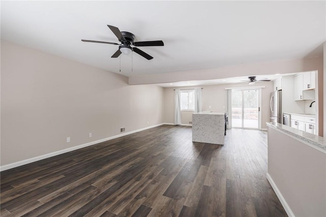 unfurnished living room with dark hardwood / wood-style flooring and sink