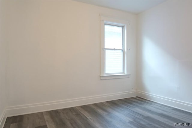 unfurnished room with dark hardwood / wood-style floors and a healthy amount of sunlight