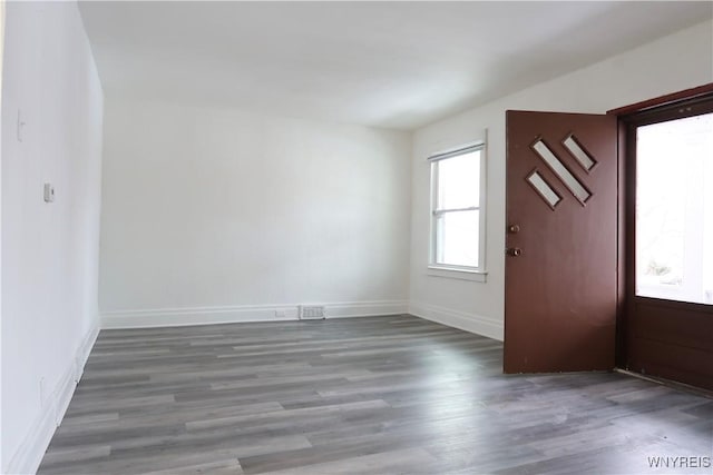 spare room featuring dark wood-type flooring