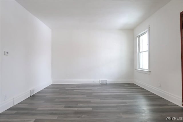 unfurnished room with dark hardwood / wood-style floors