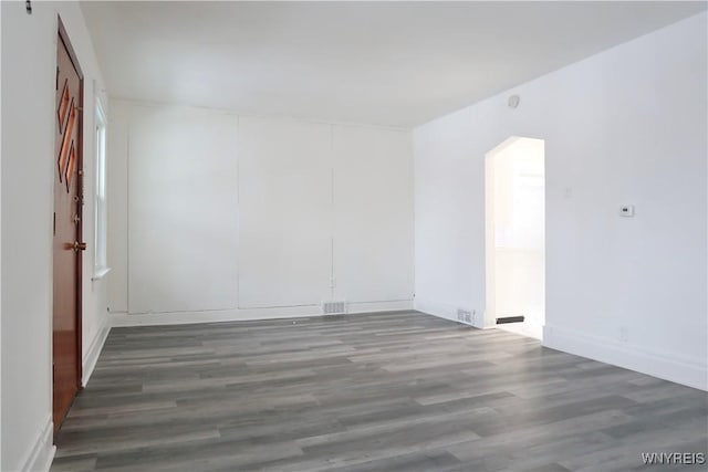 unfurnished room featuring dark hardwood / wood-style floors