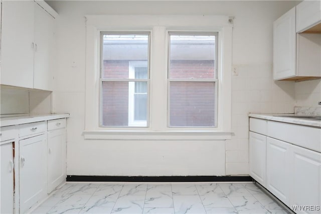 kitchen with white cabinetry and sink