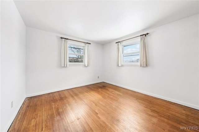 unfurnished room with hardwood / wood-style floors and a wealth of natural light