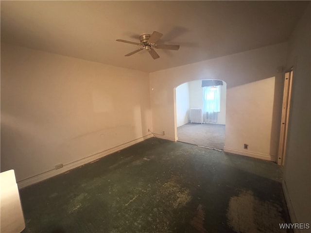 empty room with radiator heating unit and ceiling fan