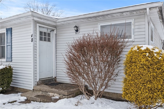 view of snow covered property entrance