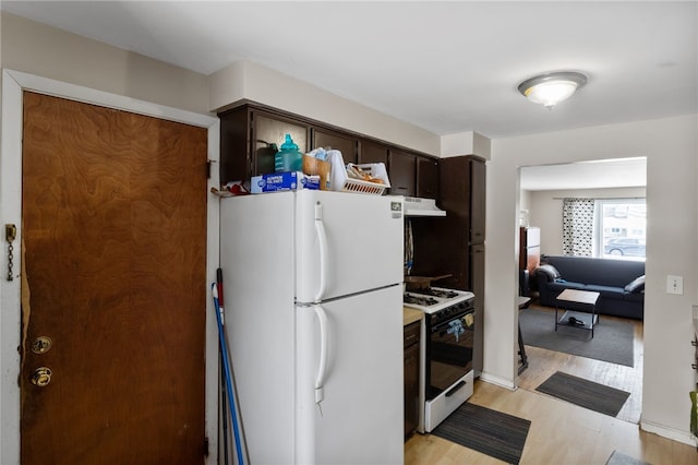 kitchen featuring light hardwood / wood-style flooring, white appliances, and dark brown cabinets