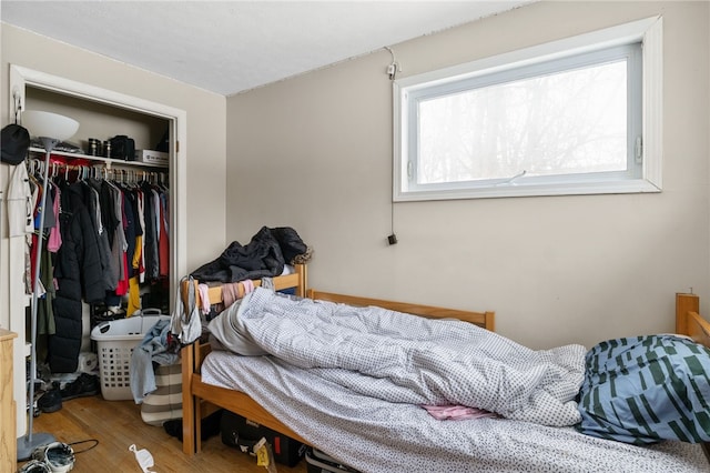 bedroom featuring hardwood / wood-style floors and a closet