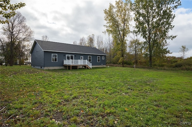 view of front of home with a wooden deck and a front yard