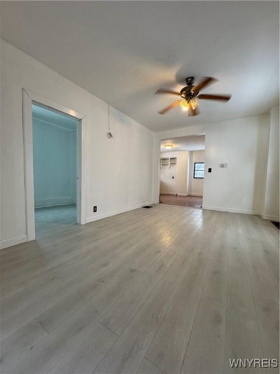 unfurnished living room featuring ceiling fan and light wood-type flooring