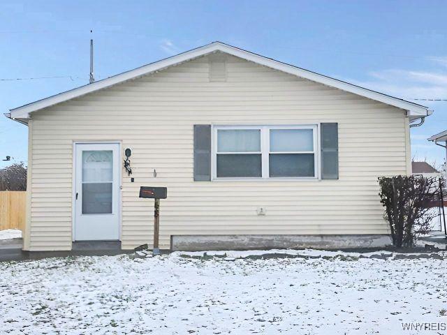 view of snow covered back of property