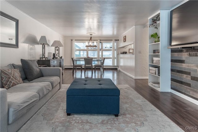 living room featuring crown molding, hardwood / wood-style flooring, and an inviting chandelier