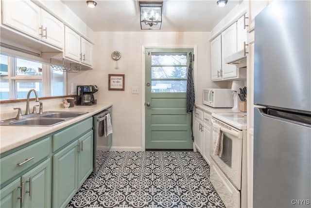 kitchen featuring white cabinetry, appliances with stainless steel finishes, light tile patterned flooring, and sink