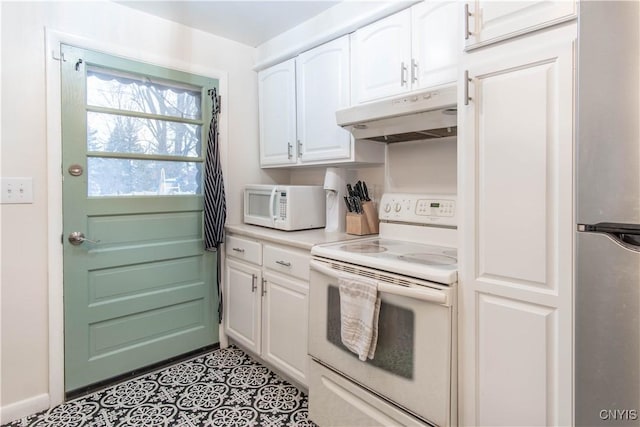 kitchen with light tile patterned flooring, white cabinets, and white appliances