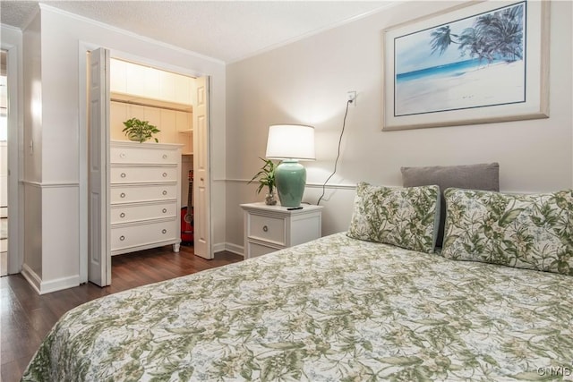 bedroom with crown molding, dark wood-type flooring, and a textured ceiling