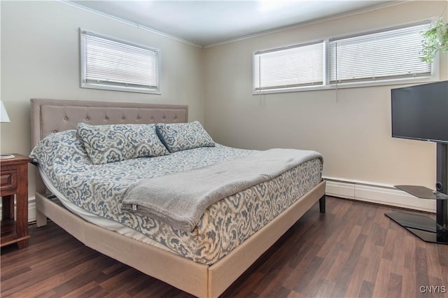 bedroom featuring dark hardwood / wood-style flooring, crown molding, and a baseboard radiator