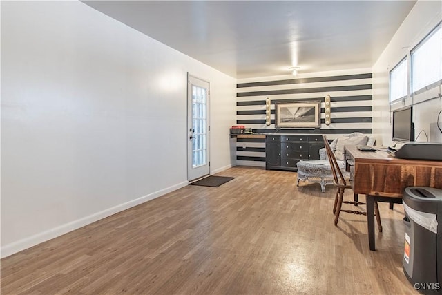 office with plenty of natural light and hardwood / wood-style floors