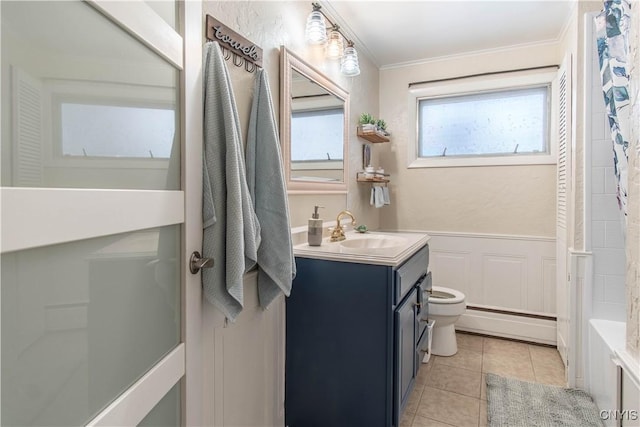 full bathroom with toilet, a baseboard radiator, vanity, ornamental molding, and tile patterned flooring