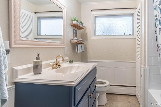 bathroom featuring vanity, plenty of natural light, tile patterned floors, and toilet