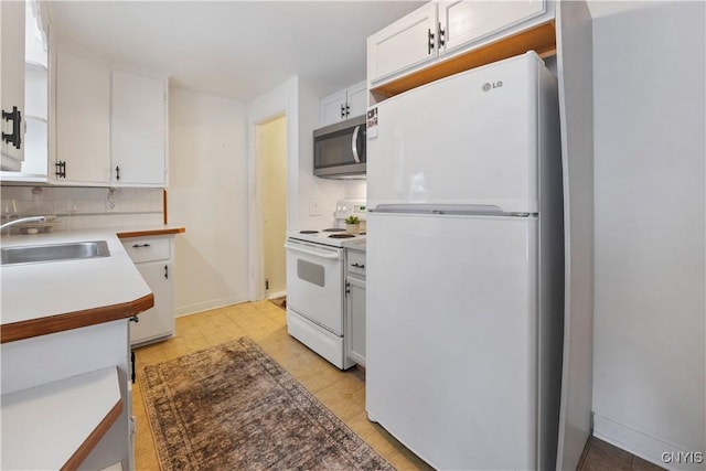 kitchen featuring white cabinetry, white appliances, sink, and backsplash