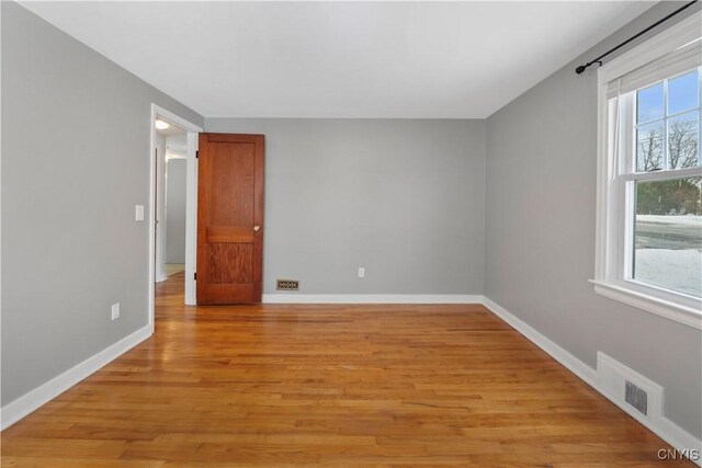 spare room featuring light wood-type flooring