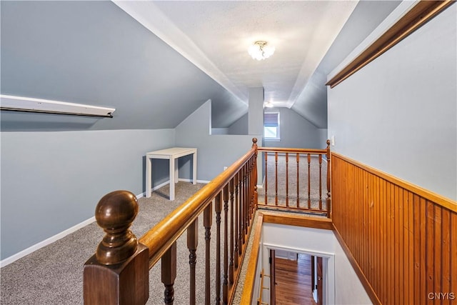 stairs with lofted ceiling and carpet floors