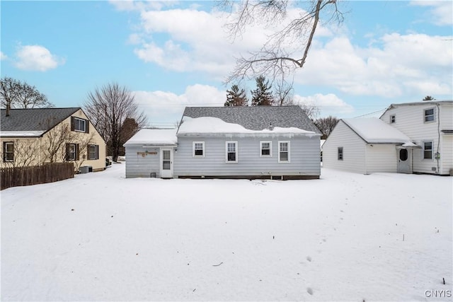 view of snow covered rear of property