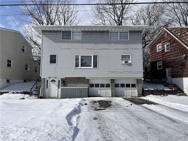 view of front property featuring a garage and cooling unit