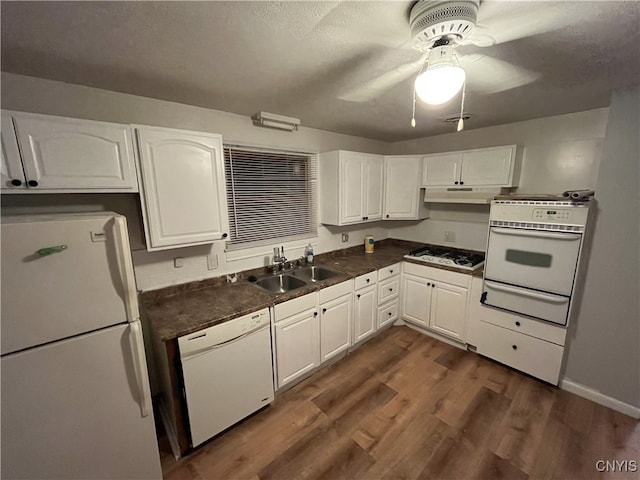 kitchen with sink, white cabinets, ceiling fan, dark wood-type flooring, and white appliances