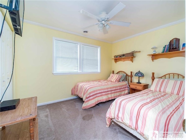 carpeted bedroom with ornamental molding and ceiling fan