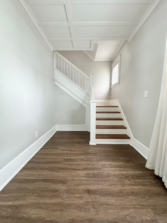 staircase with coffered ceiling, hardwood / wood-style floors, and ornamental molding