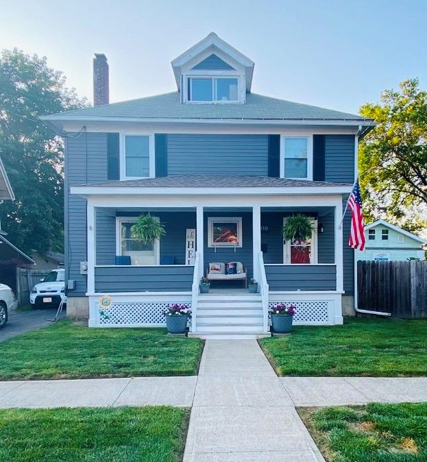 view of front of home featuring a front yard and a porch