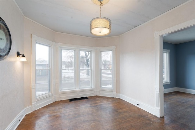 unfurnished dining area featuring dark hardwood / wood-style flooring and ornamental molding