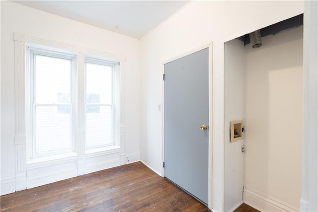 interior space featuring hookup for a washing machine and dark wood-type flooring