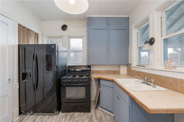 kitchen featuring light hardwood / wood-style floors, sink, and black appliances