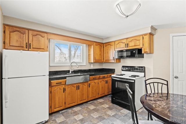 kitchen with white refrigerator, sink, and electric stove