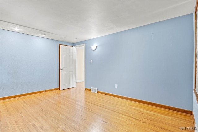 unfurnished room with light wood-type flooring