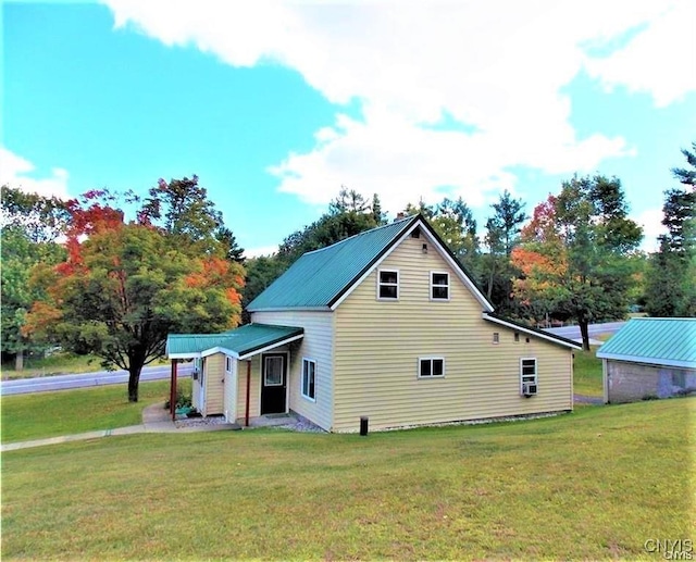 rear view of house with a yard
