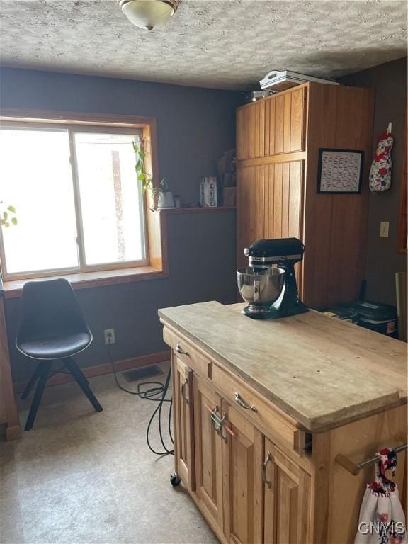 kitchen with a center island and a textured ceiling