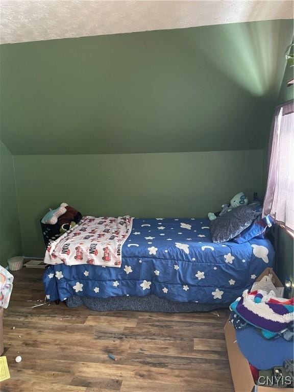 bedroom featuring lofted ceiling and dark wood-type flooring
