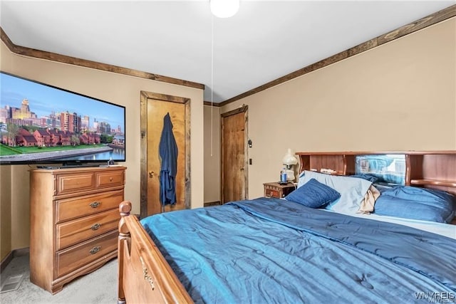 carpeted bedroom featuring ornamental molding