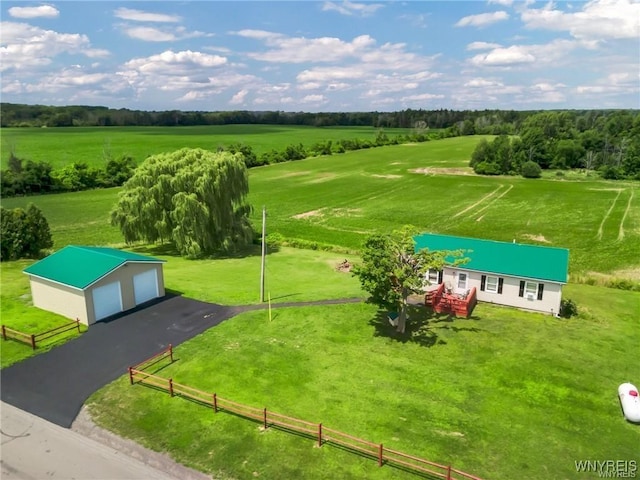 surrounding community featuring an outdoor structure, a rural view, and a lawn