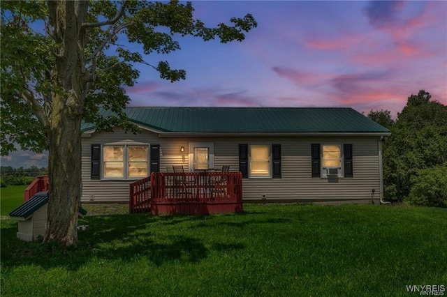 view of front of home with a wooden deck, a lawn, and cooling unit