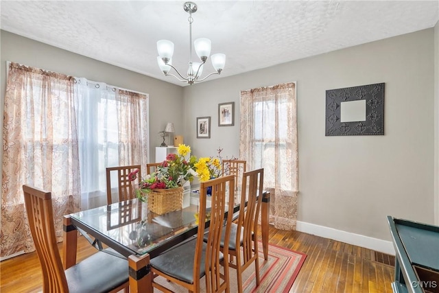 dining space featuring hardwood / wood-style flooring, plenty of natural light, and a textured ceiling