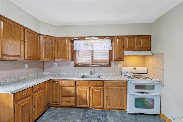 kitchen featuring tasteful backsplash, sink, and range with two ovens