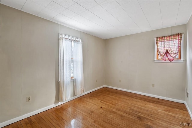 spare room featuring wood-type flooring