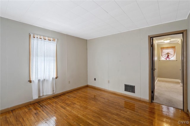 spare room with hardwood / wood-style floors