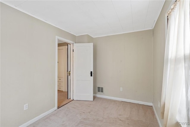 carpeted empty room with crown molding