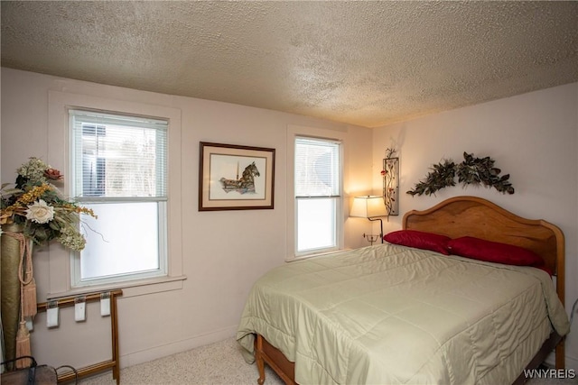 carpeted bedroom with a textured ceiling