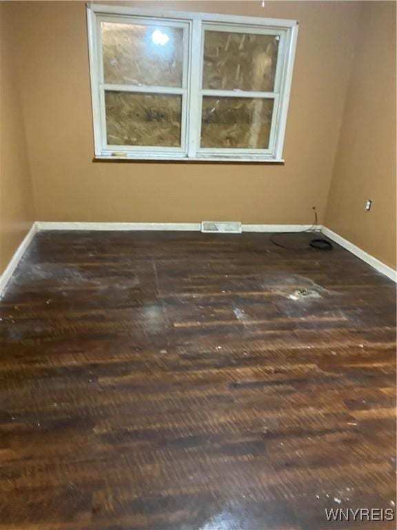 spare room featuring dark hardwood / wood-style flooring